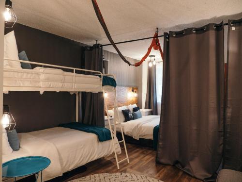 a bedroom with two bunk beds and a table at LOGE Bend in Bend