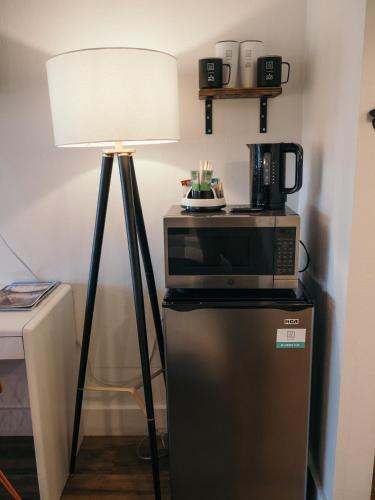a lamp sitting next to a microwave and a refrigerator at LOGE Bend in Bend