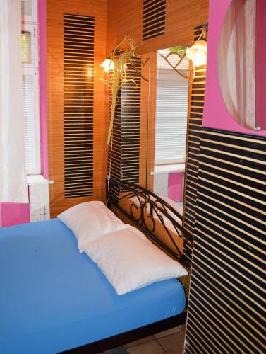 a bedroom with a bed in a room with windows at Hostel Golden Gates in Kyiv