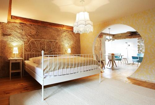 a bedroom with a white bed in a room at hotel rainhof scheune & naturpark restaurant (Kirchzarten) in Kirchzarten
