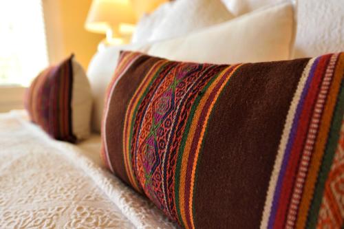 a close up of a bed with a pillow on it at Casa Culinaria - The Gourmet Inn in Santa Fe