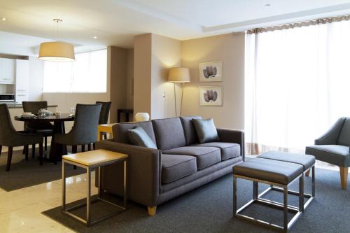 a living room with a couch and a dining room at Pennsylvania Suites in Mexico City