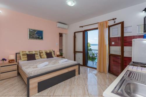 sypialnia z łóżkiem i widokiem na ocean w obiekcie Apartments Verica - 15 m from beach w mieście Krilo