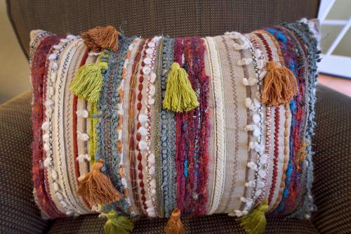 a blanket on a couch with beads and tassels at Casa Culinaria - The Gourmet Inn in Santa Fe