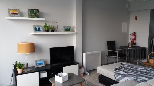 a living room with a bed and a table at Amazing view to the sea & port bay in Mosteiros in Mosteiros