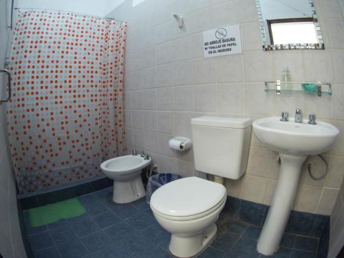 a bathroom with a toilet and a sink at Tilcara Hostal Niña Coya in Tilcara