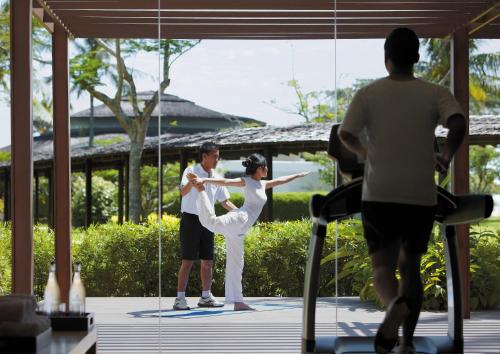a bride and groom dancing in front of a mirror at Shangri-La Rasa Ria, Kota Kinabalu in Kota Kinabalu