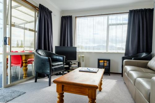 a living room with a couch and a table at Esplanade Motels in Gore