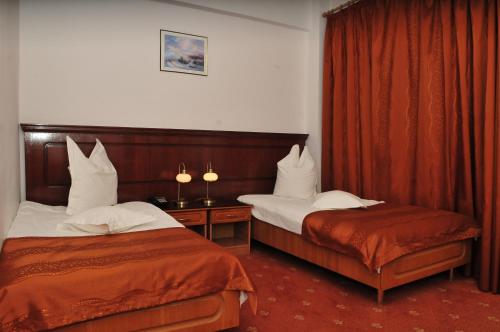 Postel nebo postele na pokoji v ubytování Hotel Emma Est