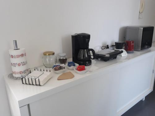a white counter with a coffee maker and other items on it at CharmeRooms Villa Moroni in Stezzano