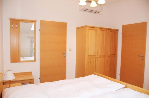 a bedroom with a bed and a wooden cabinet at Privatzimmer Familie Schwarz in Vienna