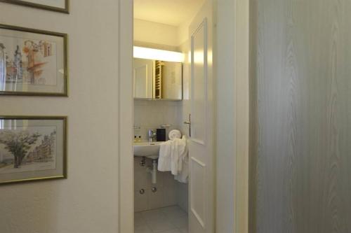 a bathroom with a sink and a mirror at Chalchboda in Arosa