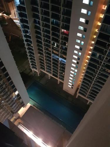 an aerial view of a pool in a building at night at SHAHALAM ALLBESS@TREFOIL in Setia Alam