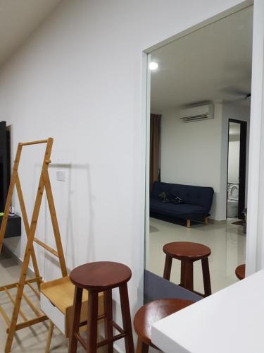 a room with two chairs and a mirror at SHAHALAM ALLBESS@TREFOIL in Setia Alam