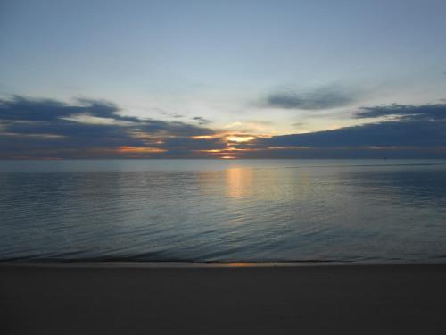 a sunset over the ocean on a beach at #33 Bungalow Seaside Hotel & Victors RV Park in San Felipe