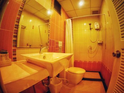 a bathroom with a sink and a shower and a toilet at Lanta at Home - SHA Extra Plus in Ko Lanta
