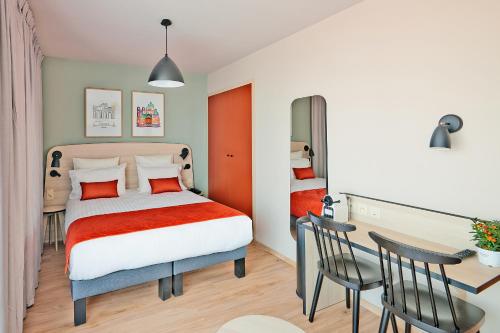 Ένα ή περισσότερα κρεβάτια σε δωμάτιο στο Appart'City Confort Bruxelles Centre Gare du Midi