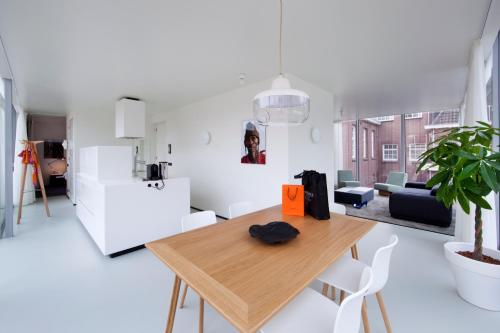 a living room with a wooden table and a couch at Urban Residences Maastricht in Maastricht
