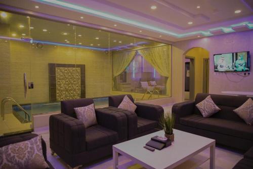 a living room with two couches and a table at Kinda Resort Luxury Villas in Taif