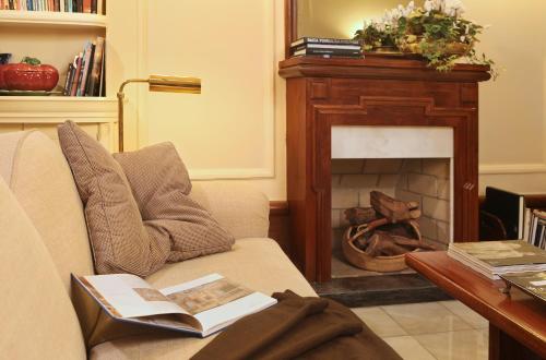 a living room with a couch and a fireplace at Hotel Britania Art Deco - Lisbon Heritage Collection - Avenida in Lisbon