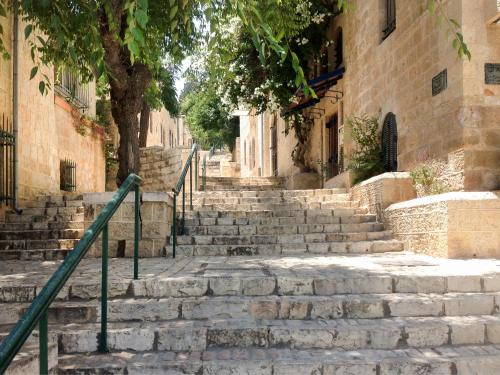 a set of stone stairs in an alley with trees at Ibis Styles Jerusalem City Center - An AccorHotels Brand in Jerusalem