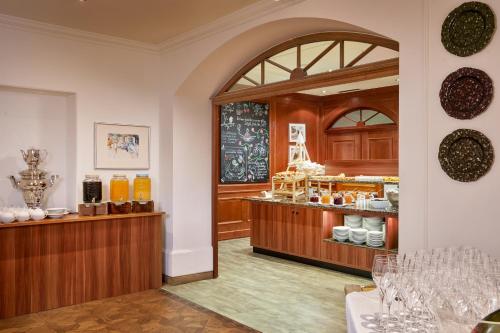 a restaurant with a counter and a store at Das Alpenhaus Gasteinertal in Bad Hofgastein