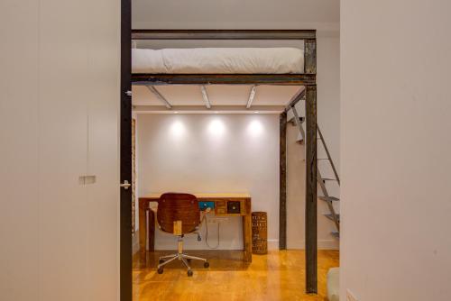 a room with a bunk bed and a desk and a chair at Luxury Rooms Madrid Center in Madrid