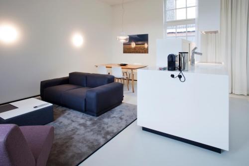 a living room with a couch and a table at Urban Residences Maastricht in Maastricht