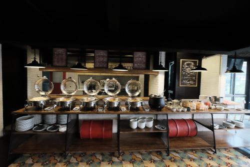 a kitchen with a counter with pots and pans at Namin Dago Hotel in Bandung