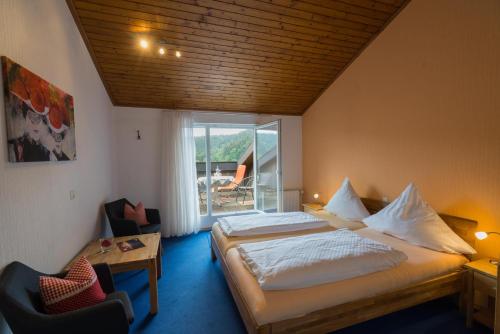 a bedroom with a large bed and a balcony at Pension Himmelreich in Glatt