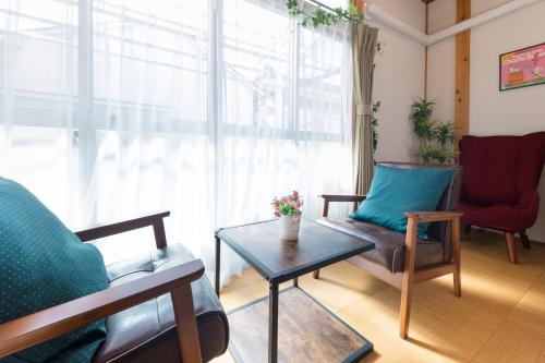 a living room with a couch and a table at Suiren Residential Suite Tokyo in Tokyo