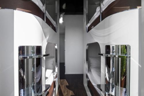 a room with two bunk beds and two mirrors at Steel House Copenhagen in Copenhagen