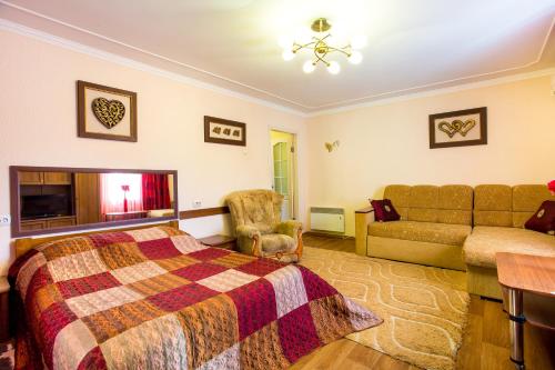 a bedroom with a bed and a couch at Summer in the Center of the City in Kherson