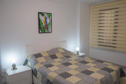 a bedroom with a bed with a checkered blanket at Viña del Mar II in Playa Fañabe