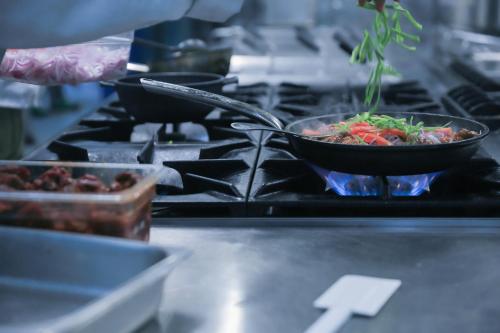 a stove top with two bowls of food on it at Swiss Inn Nexus Hotel in Addis Ababa