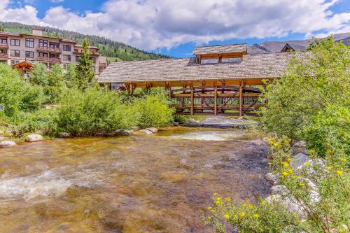 a bridge over a river in front of a lodge at Tucker Mountain Lodge 321 in Copper Mountain