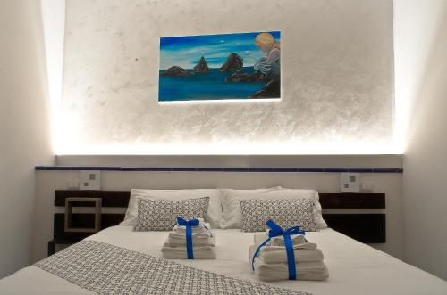 a bedroom with a bed with blue bows on it at B&B Vietri 360 in Vietri sul Mare