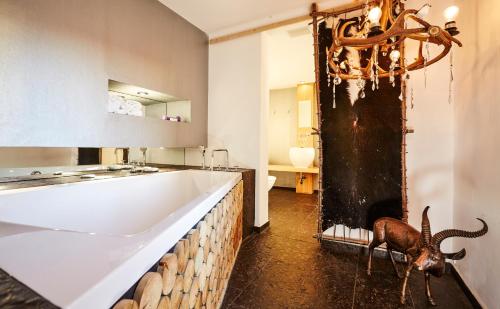 a bathroom with a large tub and a sink at Der Zauberlehrling in Stuttgart
