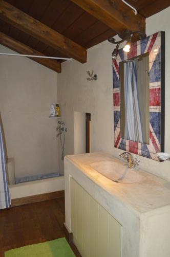 a bathroom with a sink and a mirror and a tub at Sansa Stark Chalet in Arachova