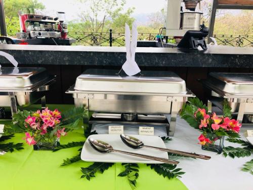 a table with tongs and utensils on a table at Hotel Las Puertas de Tepoztlan in Tepoztlán