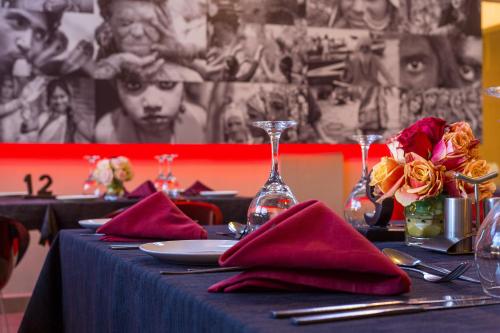 a table with a blue table cloth and red napkins at Bliss Resort in Nyali