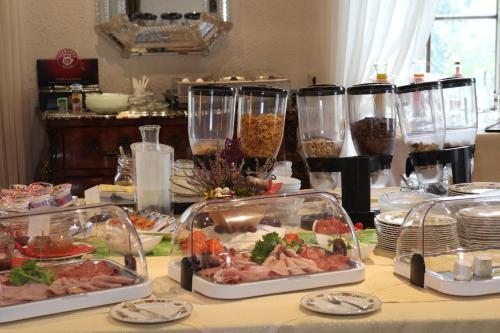 a table with many dishes of food on it at Schwarzwaldhotel Stollen in Gutach im Breisgau