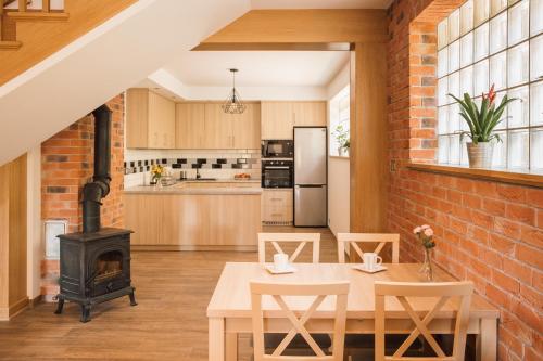 an open kitchen and dining room with a brick wall at Przy Dolinie in Paczółtowice