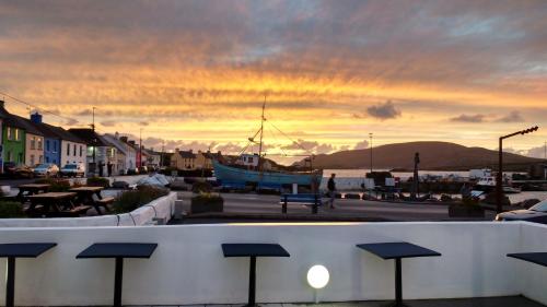 a boat is docked in a marina at sunset at Reenglas House in Valentia Island