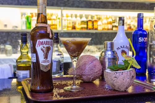 a bottle of alcohol sitting on a bar with a drink at Bliss Resort in Nyali