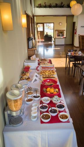 a long table with many different types of food on it at Hotel Poincenot in El Chalten