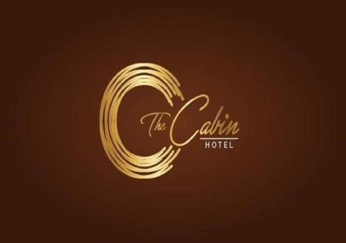 a gold logo for the california hotel at The Cabin Hotel in Accra