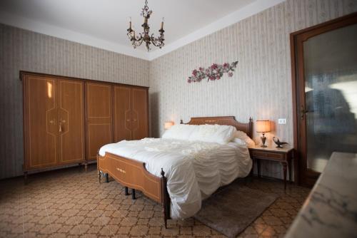 a bedroom with a bed and a table and a chandelier at Casa Serena in Solonghello