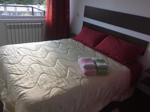 a bedroom with a bed with two towels on it at Buşteni House in Buşteni