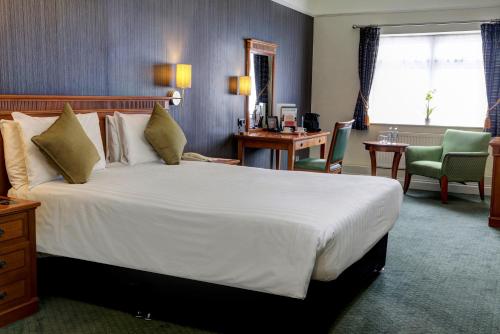 a hotel room with a large bed and a desk at Best Western Thurrock Hotel in Grays Thurrock